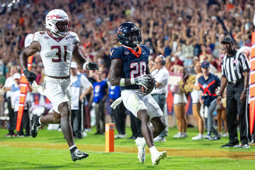 Virginia running back Xavier Brown (20) receives the ball for a touchdown during the second half of an NCAA college football game, Friday, Sept. 26 2025, in Charlottesville, Va. (AP Photo/Robert Simmons) Virginia running back Xavier Brown (20) receives the ball for a touchdown during the second half of an NCAA college football game, Friday, Sept. 26 2025, in Charlottesville, Va. (AP Photo/Robert Simmons)