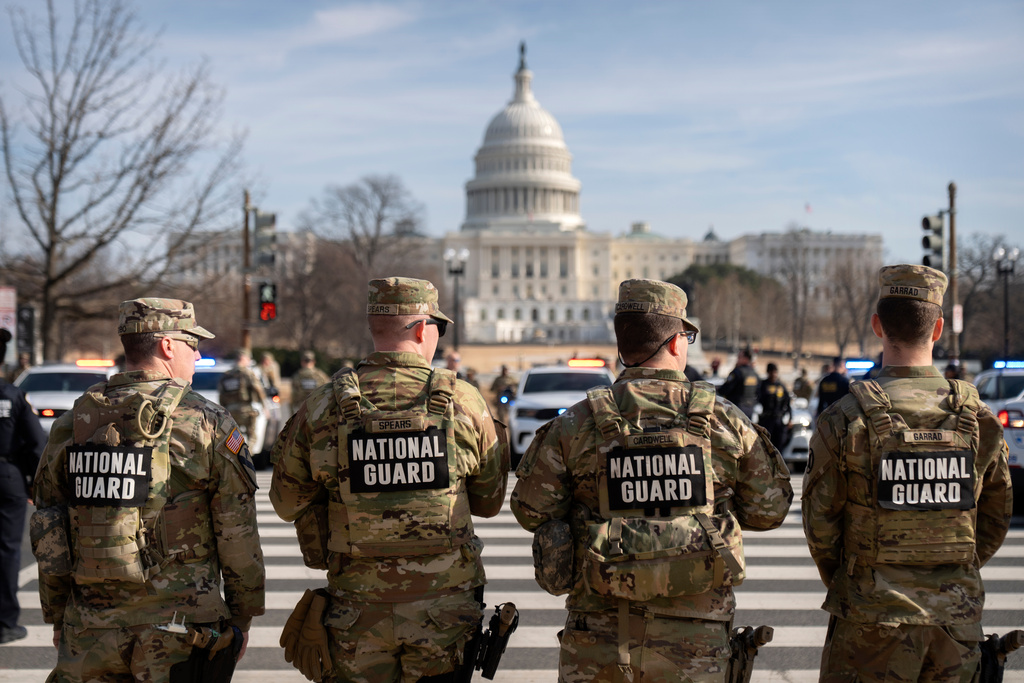 National Guard members stand before the body of Metropolitan Police Department officer Terry Bennett is driven past the Capitol, Thursday, Jan. 8, 2026, in Washington. (AP Photo/Mark Schiefelbein)
