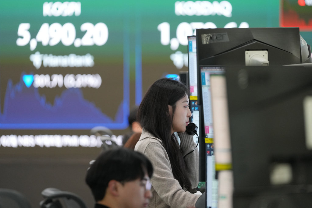 A dealer talks on the phone at a dealing room of Hana Bank in Seoul, South Korea, Wednesday, March 4, 2026. (AP Photo/Lee Jin-man)