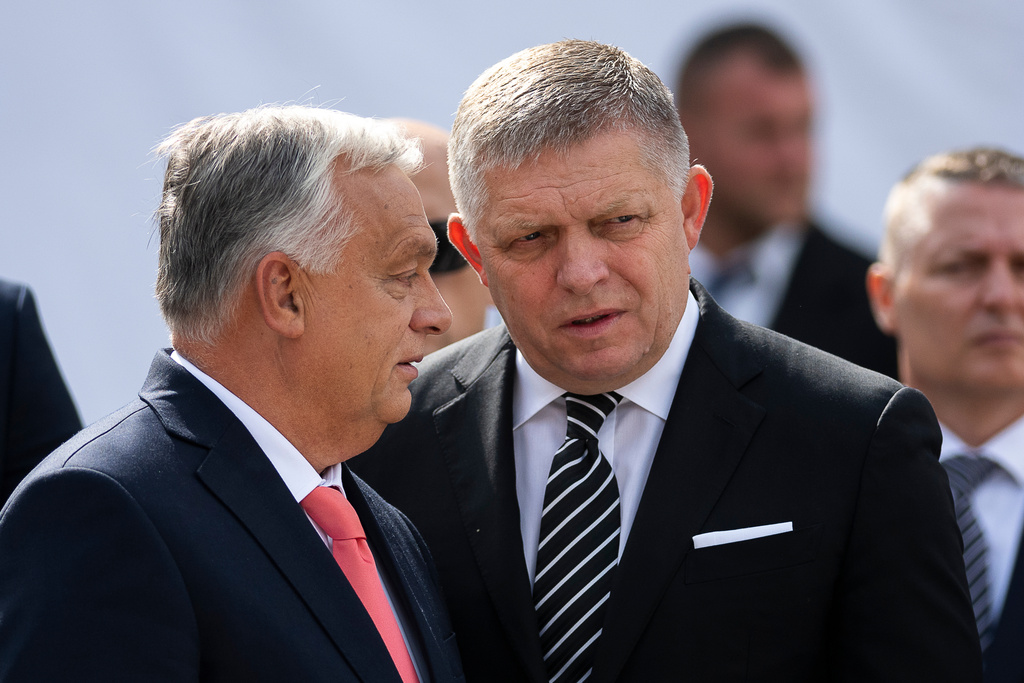 Hungary's Prime Minister Viktor Orban, left, and his Slovakian counterpart Robert Fico talk to each other before delivering their speeches during the 130th anniversary celebration of Mária Valeria Bridge in Esztergom, Hungary, on Sunday, Sept. 28, 2025. (AP Photo/Denes Erdos)