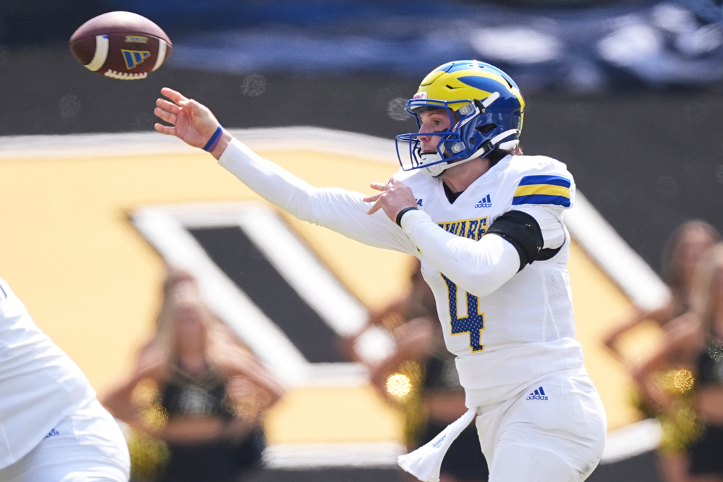 Delaware quarterback Nick Minicucci rolls out to pass the ball against Colorado in the first half of an NCAA college football game Saturday, Sept. 6, 2025, in Boulder, Colo. (AP Photo/David Zalubowski)