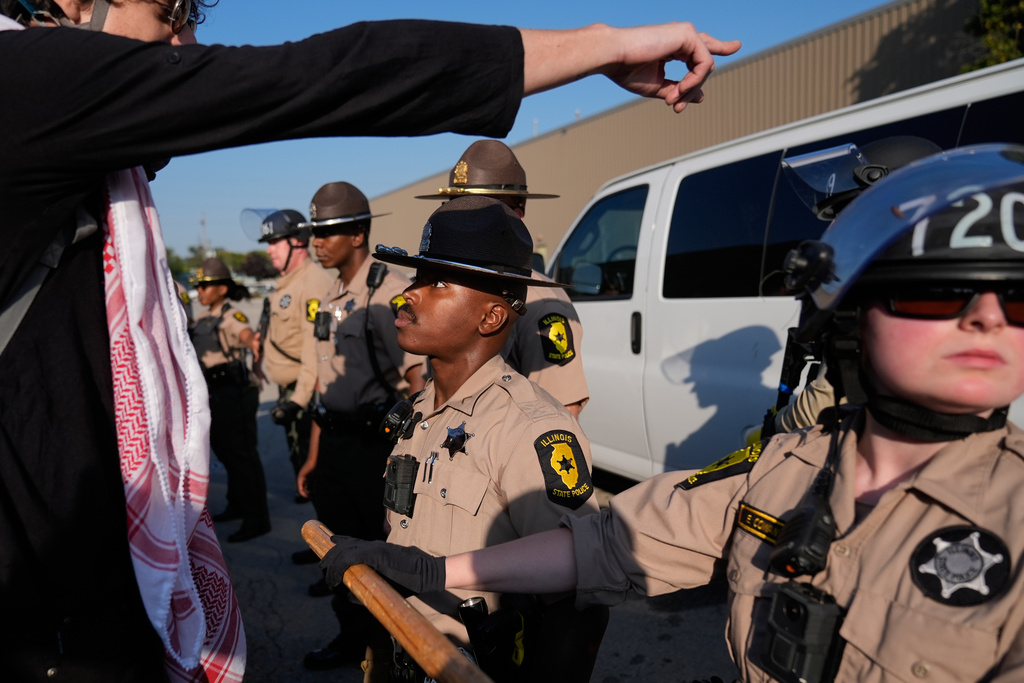 Law enforcement hold back protesters near an Immigration and Customs Enforcement facility in Broadview, Ill., Friday, Oct. 3, 2025. (AP Photo/Erin Hooley)