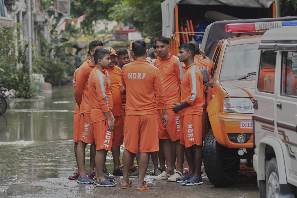 Soldiers from National Disaster Relief Force talk before starting the rescue operation after the river Yamuna, swollen by incessant rain in the higher regions, overran its banks, in New Delhi, India, Friday, Sept. 5, 2025. (AP Photo/Manish Swarup)