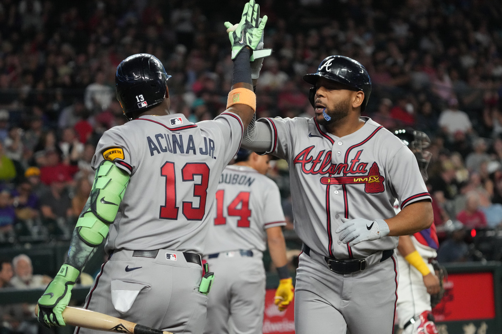 Atlanta Braves' Dominic Smith celebrates with Ronald Acuña Jr. (13) after hitting a solo home run against the Arizona Diamondbacks in the third inning of a baseball game, Thursday, April 2, 2026, in Phoenix. (AP Photo/Rick Scuteri)