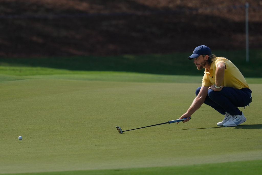 Tommy Fleetwood of England lines up a putt on the 1st green during the third round of World Tour Golf Championship at Jumeirah Golf Estates, in Dubai, United Arab Emirates, Saturday, Nov. 15, 2025. (AP Photo/Altaf Qadri)