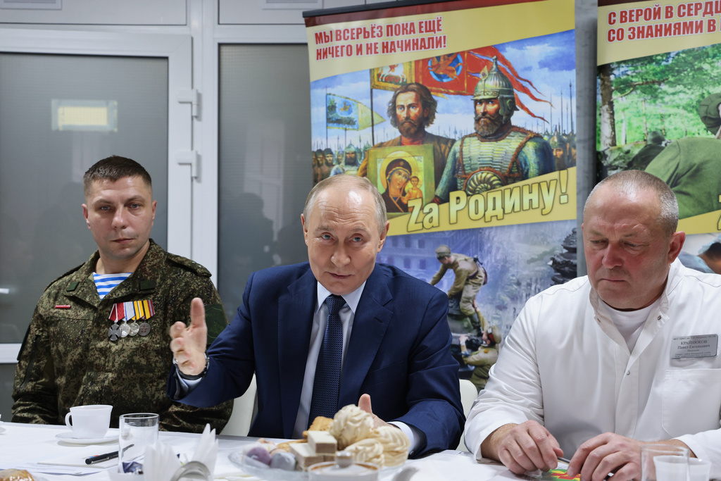 Russian President Vladimir Putin, center, talks with Russian servicemen who fought in Ukraine and Pavel Krainyukov, right, head of the Mandryk Central Military Clinical Hospital, in Moscow, Russia, Wednesday, Oct. 29, 2025. (Vladimir Gerdo, Sputnik, Kremlin Pool Photo via AP)