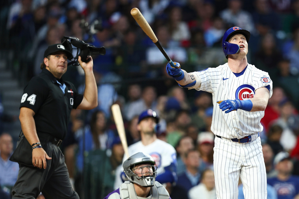 Chicago Cubs' Pete Crow-Armstrong, right, watches his home run as the umpire, back left, and Colorado Rockies catcher Hunter Goodman, back center, watch during the fourth inning of a baseball game in Chicago, Wednesday, June 17, 2026. (AP Photo/Jessie Alcheh)