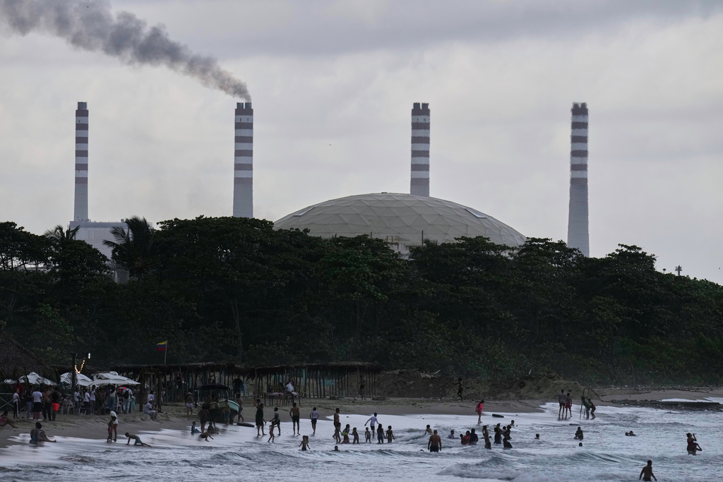 The El Palito refinery rises above a beach in Puerto Cabello, Venezuela, Sunday, Dec. 21, 2025. (AP Photo/Matias Delacroix)