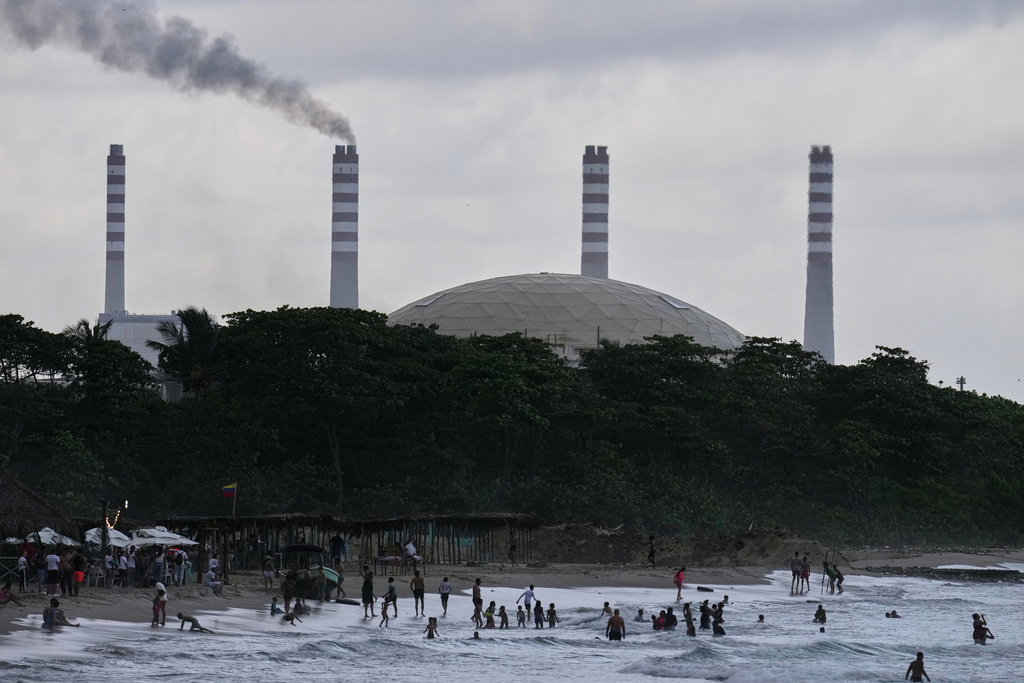 The El Palito refinery rises above a beach in Puerto Cabello, Venezuela, Sunday, Dec. 21, 2025. (AP Photo/Matias Delacroix)