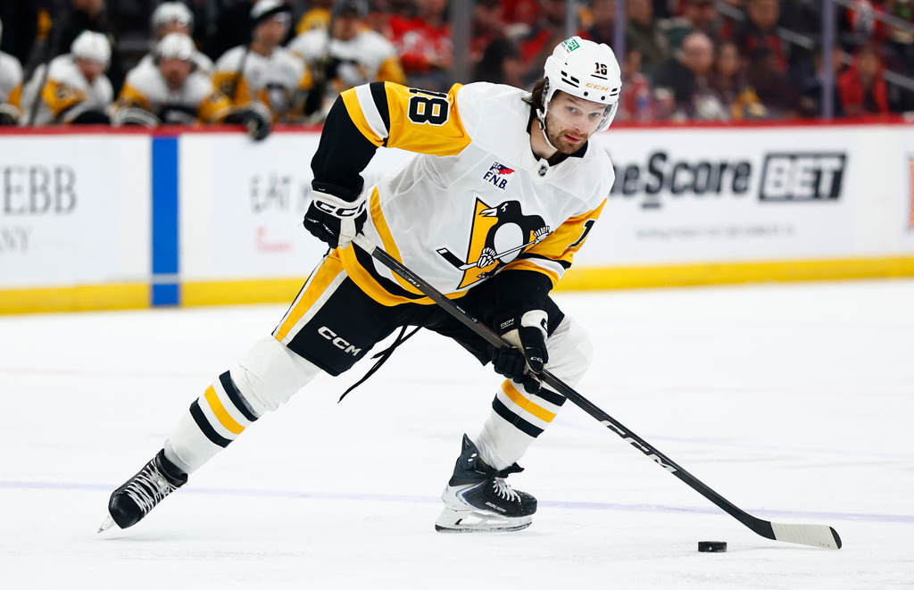 Pittsburgh Penguins center Tommy Novak skates with the puck during the first period of an NHL hockey game against the New Jersey Devils, Thursday, April 9, 2026, in Newark, N.J. (AP Photo/Noah K. Murray)