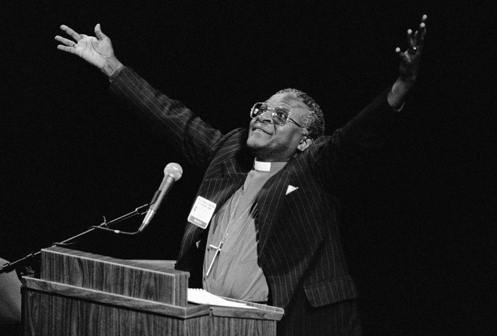 FILE - South African Bishop Desmond Tutu denounces his country's apartheid policy of racial separation in New Orleans, Sept. 7, 1982. (AP Photo/Jack Thornell, File)