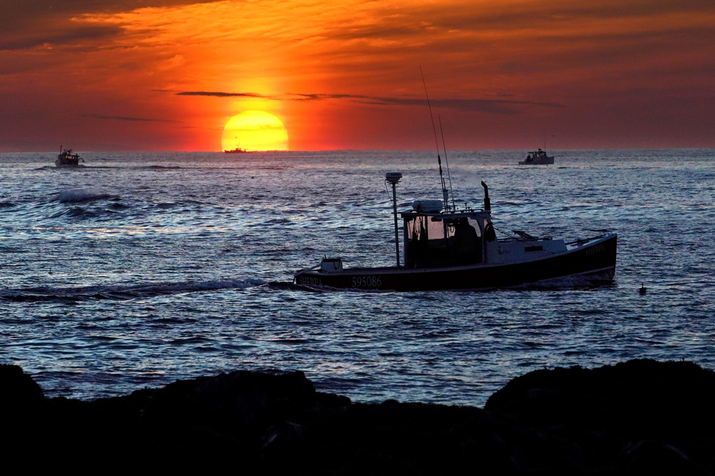 FILE - Lobster fishermen work at sunrise, Sept. 8, 2022, off Kennebunkport, Maine. (AP Photo/Robert F. Bukaty, File)