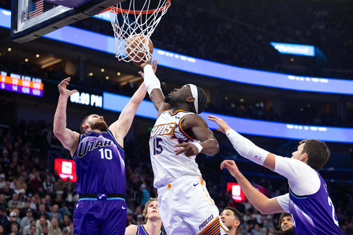 Phoenix Suns center Mark Williams (15) shoots over Utah Jazz guard Avi Mykhailiuk (10) during the first half of an NBA basketball game, Monday, Oct. 27, 2025, in Salt Lake City. (AP Photo/Anna Fuder) Phoenix Suns center Mark Williams (15) shoots over Utah Jazz guard Avi Mykhailiuk (10) during the first half of an NBA basketball game, Monday, Oct. 27, 2025, in Salt Lake City. (AP Photo/Anna Fuder)