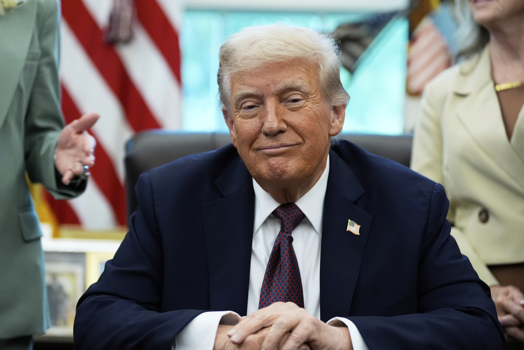 President Donald Trump listens before signing a memorandum in the Oval Office of the White House, Monday, Sept. 15, 2025, in Washington. (AP Photo/Alex Brandon)