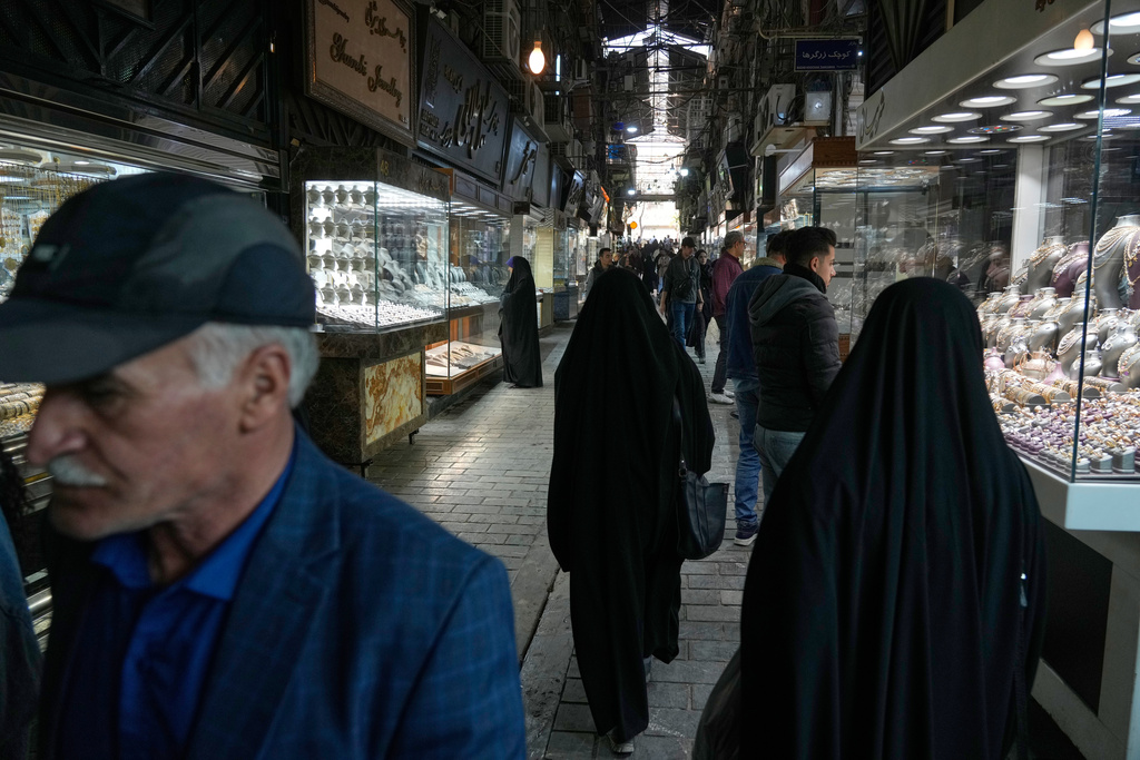 People walk at a gold market in Tehran's Grand Bazaar, Iran, Saturday, Nov. 29, 2025. (AP Photo/Vahid Salemi)