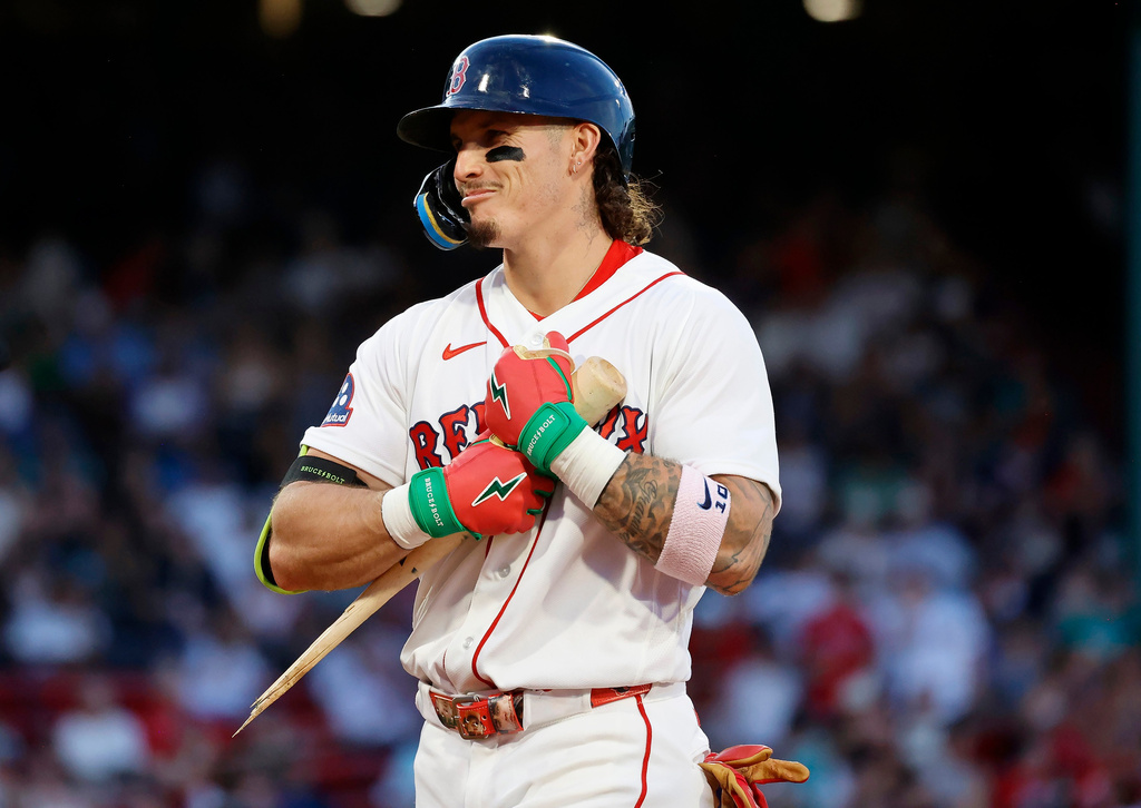 Boston Red Sox player Jarren Duran hugs his broken bat after breaking it on a single during the fourth inning of a baseball game against the Atlanta Braves, Wednesday, May 27, 2026, in Boston. (AP Photo/Mary Schwalm)