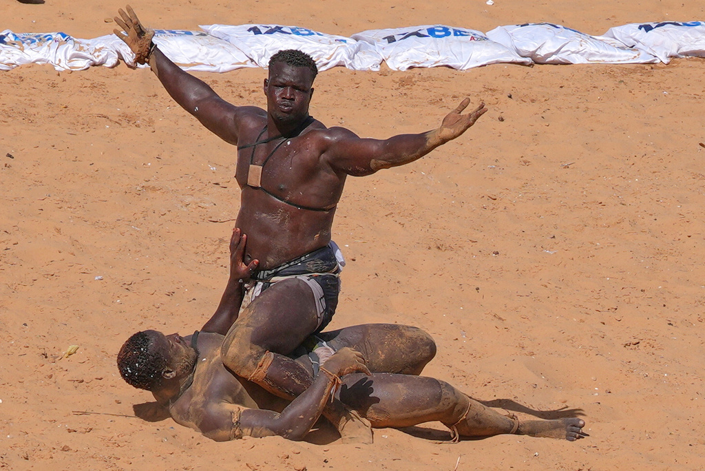 Wrestlers compete at the national wrestling arena in Dakar, Senegal, Sunday, April 5, 2026. (AP Photo/Misper Apawu)
