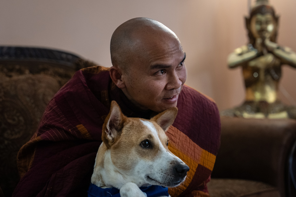 Bhikkhu Pannakara, a Buddhist monk who led a Walk for Peace from Fort Worth, Texas, to Washington, D.C., sits with his dog, Aloka, before an event at Wat Thai of Los Angeles in the North Hollywood section of Los Angeles, Monday, July 13, 2026. (AP Photo/Jae C. Hong)
