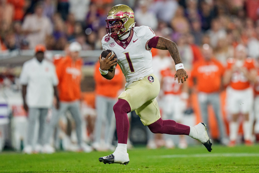 Florida State quarterback Tommy Castellanos (1) runs with the ball in the first half of an NCAA college football game against Clemson, Saturday, Nov. 8, 2025, in Clemson, S.C. (AP Photo/Jacob Kupferman)