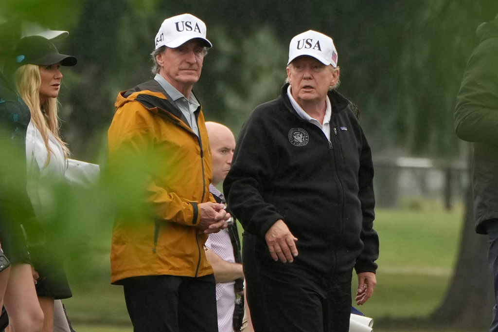 President Donald Trump, from right, and Interior Secretary Doug Burgum tour the East Potomac Park golf course, Sunday, June 28, 2026, in Washington. (AP Photo/Mark Schiefelbein)
