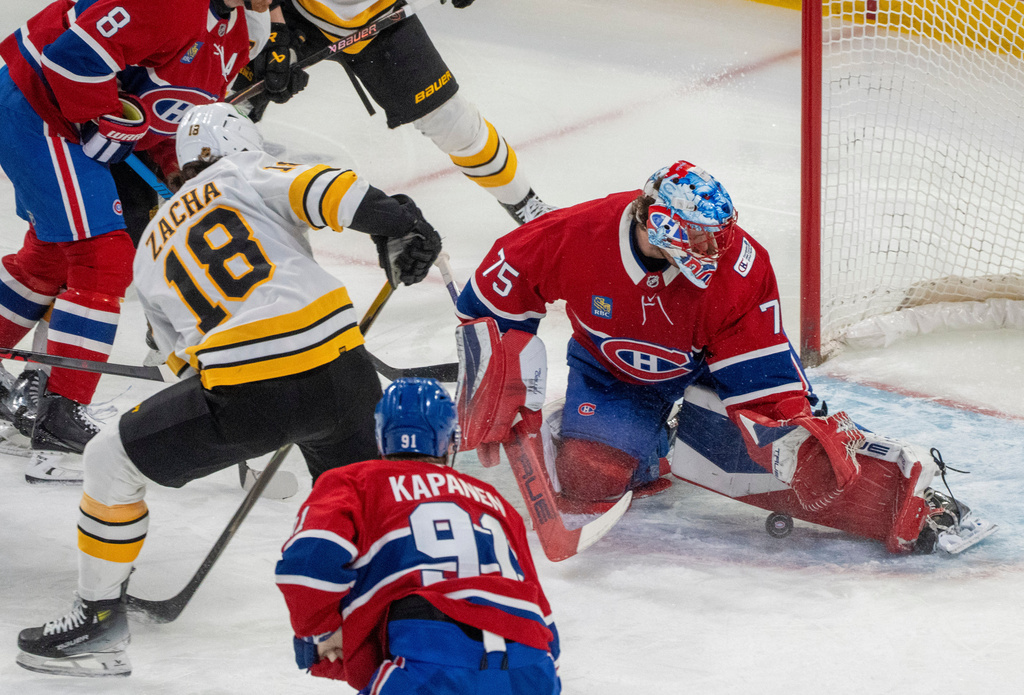 Montreal Canadiens goaltender Jakub Dobes (75) looks for the puck on a shot by Boston Bruins' Pavel Zacha (18) during the first period of an NHL hockey game in Montreal, Tuesday, March 17, 2026. (Christinne Muschi/The Canadian Press via AP)