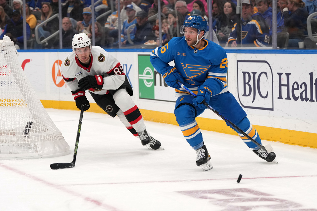 St. Louis Blues' Nathan Walker (26) looks to pass as Ottawa Senators' Lars Eller (89) defends during the second period of an NHL hockey game Friday, Nov. 28, 2025, in St. Louis. (AP Photo/Jeff Roberson)
