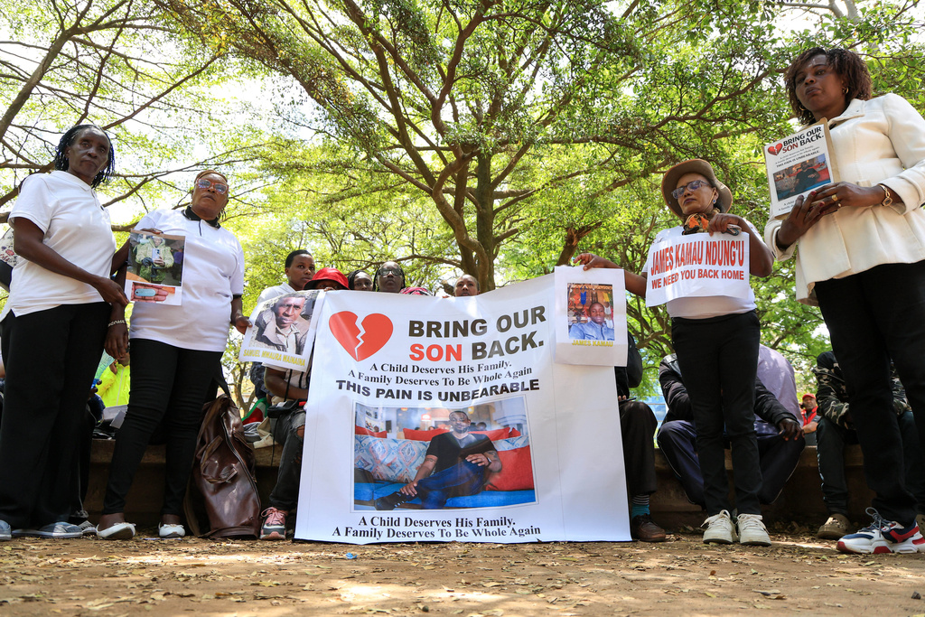 Family members of Kenyans who joined the Russian army in Ukraine hold photos of their loved ones during a protest calling on the government to urgently repatriate them and their remains in Nairobi, Thursday, Feb. 19, 2026. (AP Photo/Andrew Kasuku)
