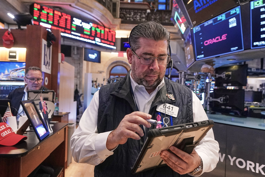 Trader Michael Capolino, right, works on the floor of the New York Stock Exchange, Tuesday, Nov. 18, 2025. (AP Photo/Richard Drew)