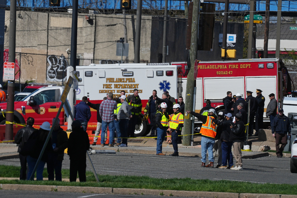 First responders gather near a partially collapsed parking garage in Philadelphia, Thursday, April 9, 2026. (AP Photo/Matt Rourke)