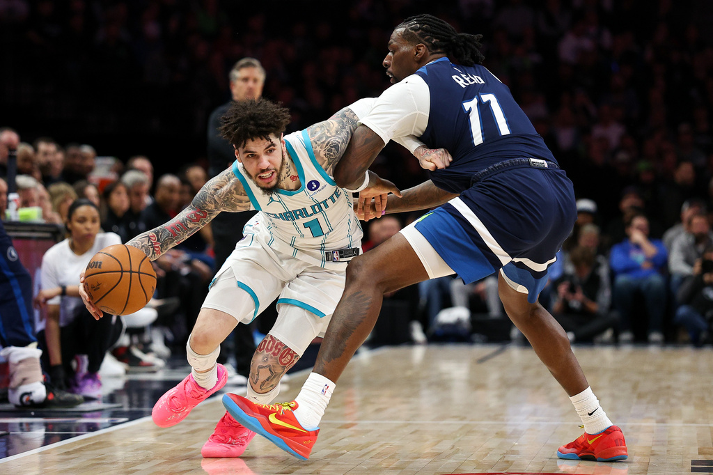 FILE - Charlotte Hornets guard LaMelo Ball (1) works around Minnesota Timberwolves center Naz Reid (11) during the second half of an NBA basketball game, April 5, 2026, in Minneapolis. (AP Photo/Matt Krohn, file)