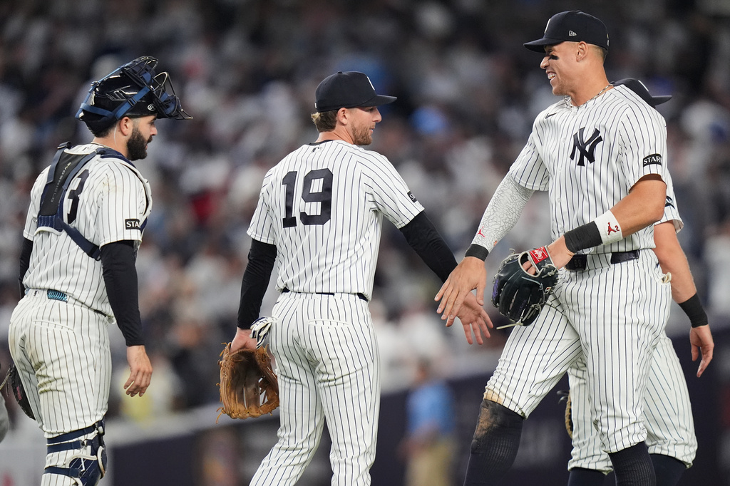 New York Yankees' Aaron Judge, right, celebrates with Ryan McMahon, center, and Austin Wells after a baseball game against the Kansas City Royals Friday, April 17, 2026, in New York. (AP Photo/Frank Franklin II)