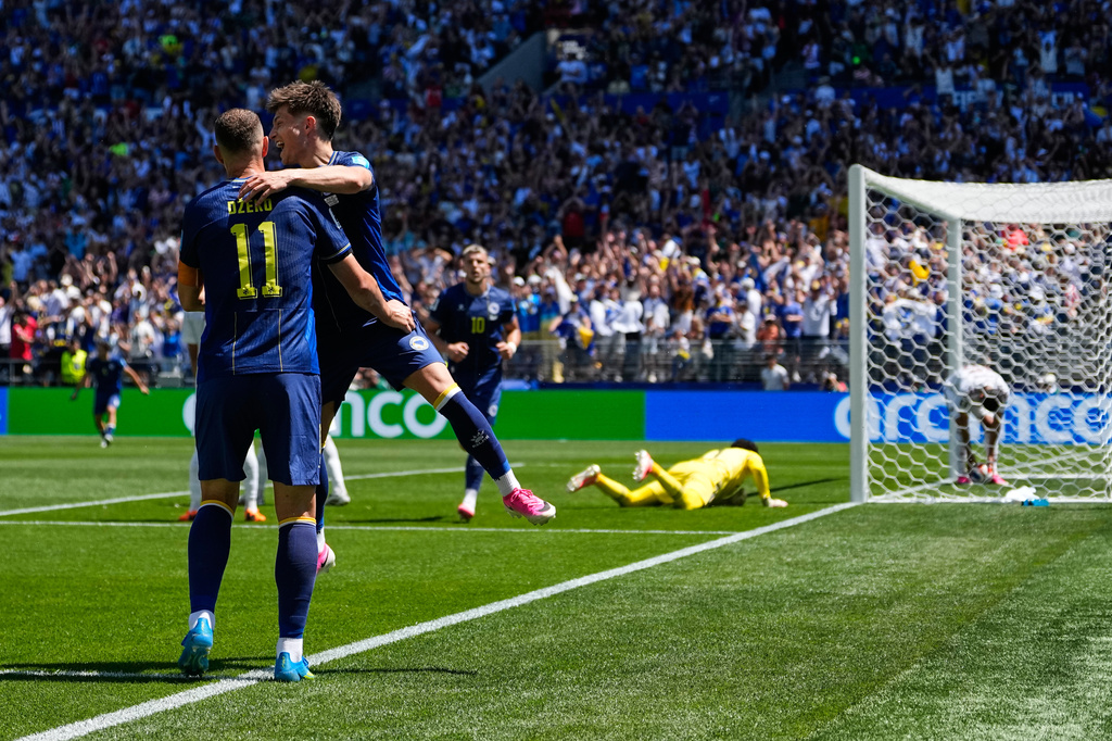Bosnia's Edin Dzeko, left, celebrates with Esmir Bajraktarevic after Qatar's Sultan Albrake scored an own goal during the World Cup Group B soccer match in Seattle, Wednesday, June 24, 2026. (AP Photo/Lindsey Wasson)