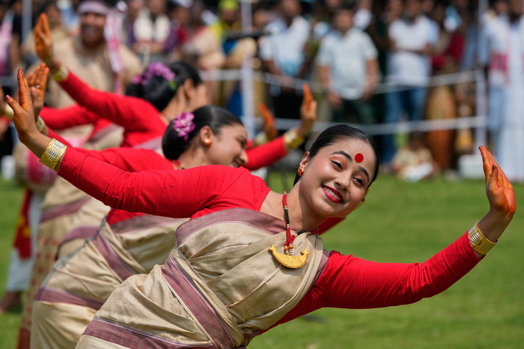 Assamese girls wearing traditional Mekhela Chadar perform the Bihu folk dance during the Rongali Bihu festival, organized by the All Assam Students Union in Guwahati, in the northeastern state of Assam, India, Tuesday, April 14, 2026. (AP Photo/Anupam Nath) CORRECTION: Corrects location detail; removes incorrect reference to Guwahati as the capital of Assam.