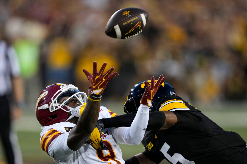 Iowa State wide receiver Omari Hayes, left, catches a pass over Iowa defensive back Anthony Hawkins during the first half of an NCAA college football game, Saturday, Sept. 12, 2026, in Iowa City, Iowa. (AP Photo/Charlie Neibergall)