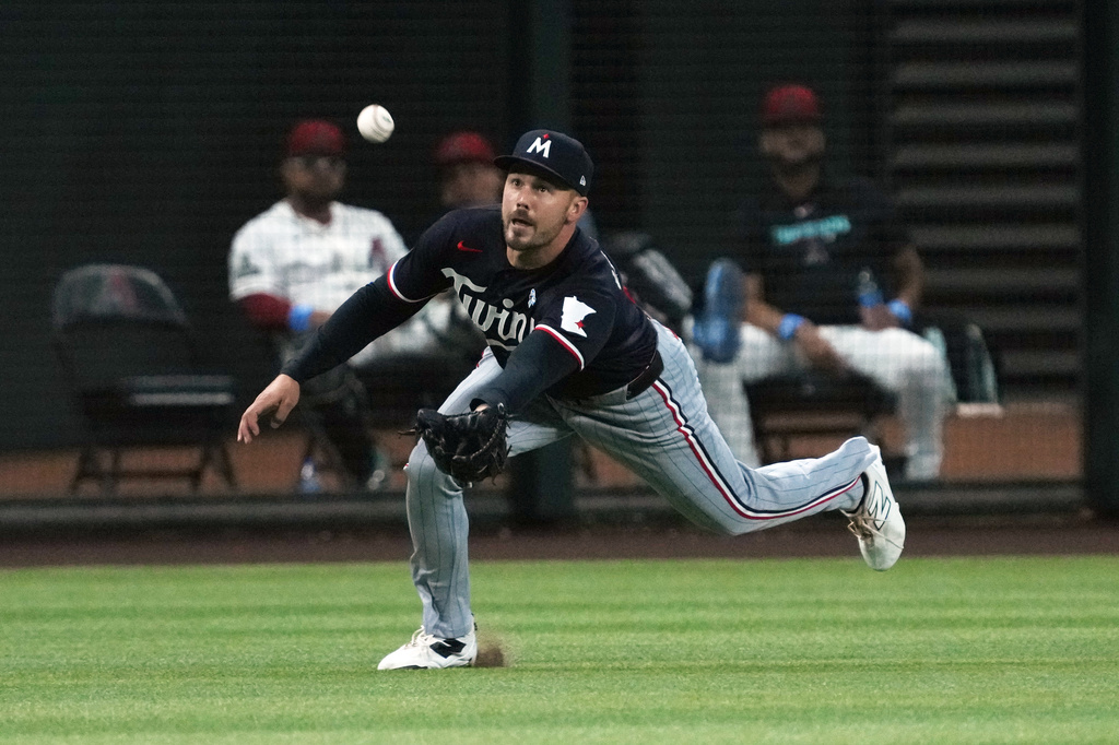 Minnesota Twins left fielder Trevor Larnach makes a diving catch on a ball hit by Arizona Diamondbacks' Geraldo Perdomo in the second inning of a baseball game, Sunday, June 21, 2026, in Phoenix. (AP Photo/Rick Scuteri)