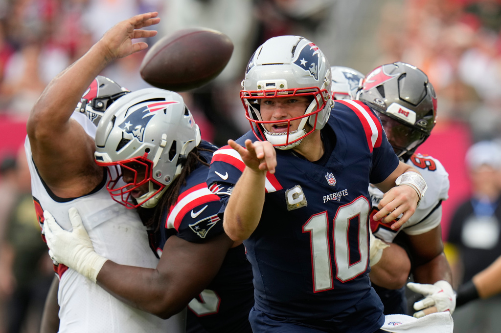 New England Patriots quarterback Drake Maye (10) throws a lateral pass against the Tampa Bay Buccaneers during the first half of an NFL football game Sunday, Nov. 9, 2025, in Tampa, Fla. (AP Photo/Chris O'Meara)