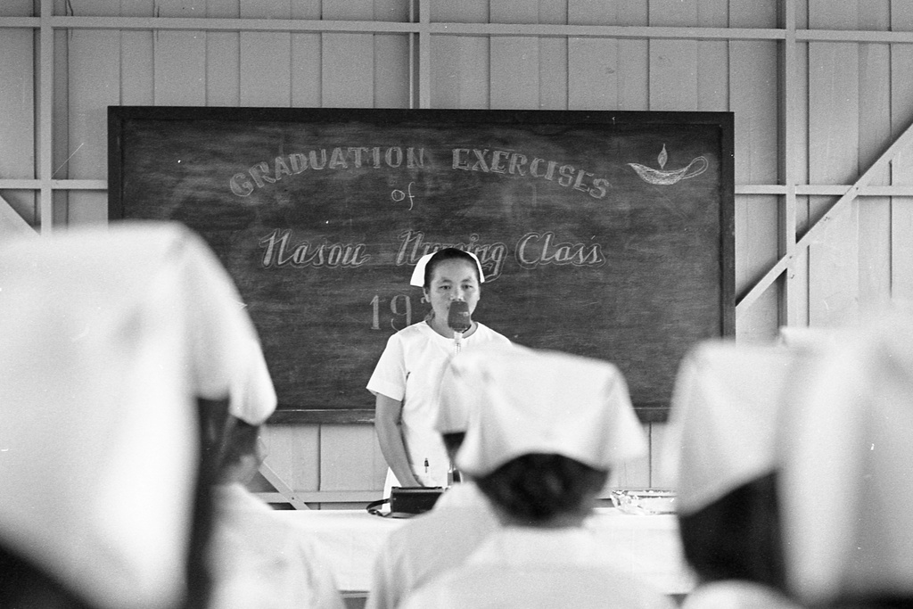 This photo provided by HmongStory Legacy shows Choua Thao, center, the late mother of Chongly "Scott" Thao, speaking during a graduation ceremony for a class of nurses at a Hmong nursing program in Ban Xon, Laos, 1971. (Galen S. Beery/HmongStory Legacy via AP)