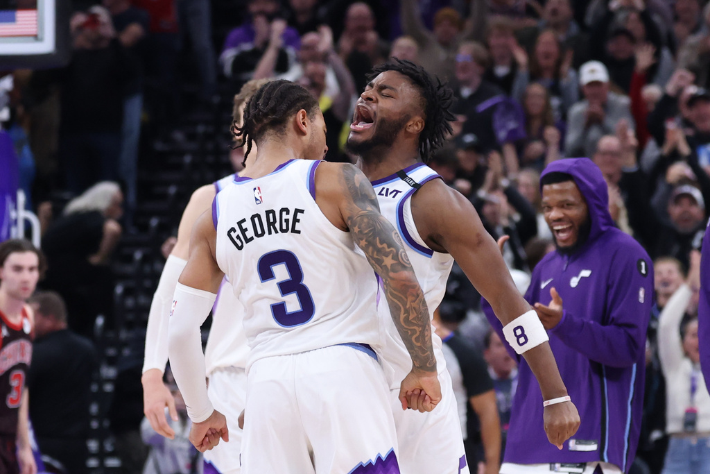 Utah Jazz guard Keyonte George (3) celebrates a three-point basket that sealed their win over the Chicago Bulls with guard Isaiah Collier, right, during the second overtime of an NBA basketball game, Sunday, Nov. 16, 2025, in Salt Lake City. (AP Photo/Rob Gray)