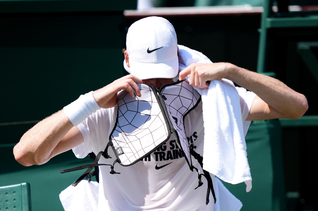 Italy's Jannik Sinner wears an ice jacket to keep cool during a practice session ahead of the Wimbledon Tennis Championships, at the All England Lawn Tennis and Croquet Club, in London, Wednesday June 24, 2026. (John Walton/PA via AP)