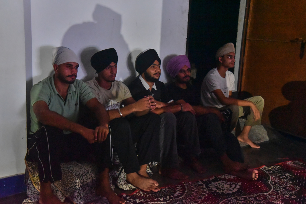 Villagers watch a special screening of the film “Satluj” at a Sikh temple in Tatley village, in Punjab's Gurdaspur district, India, Wednesday, July 8, 2026. (AP Photo/Prabhjot Gill)