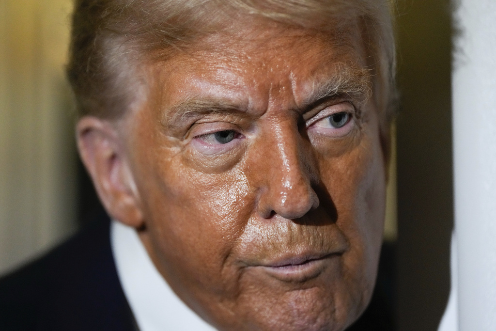 President Donald Trump speaks to reporters aboard Air Force One while en route to Joint Base Andrews, Md. after attending a memorial for conservative activist Charlie Kirk in Glendale, Ariz., Sunday, Sept. 21, 2025. (AP Photo/Julia Demaree Nikhinson)