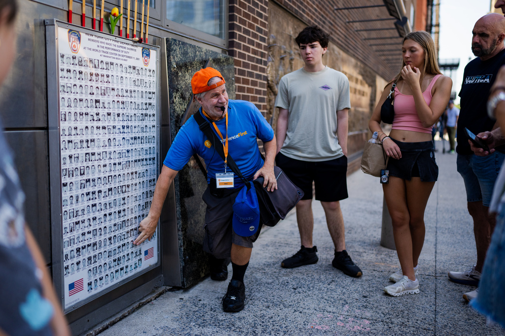 A tour guide talks about Daniel Suhr, the first firefighter to die in the 9/11 attacks on the World Trade Center, on Friday, Aug. 7, 2026, in New York. (AP Photo/Angelina Katsanis)