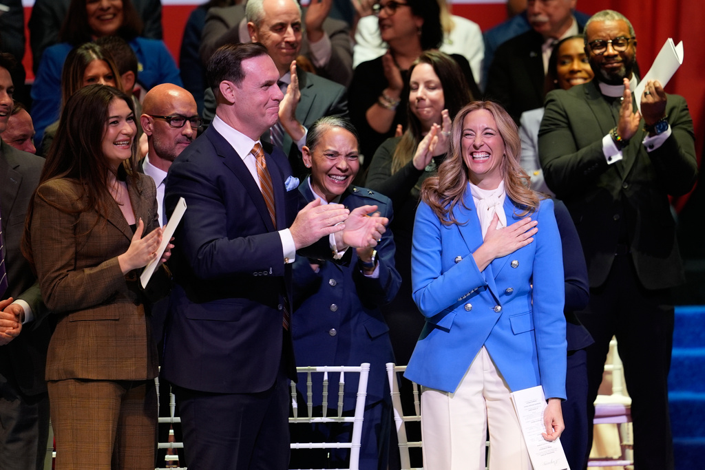 People stand and applaud for New Jersey Governor Mikie Sherrill during her inauguration ceremony in Newark, N.J., Tuesday, Jan. 20, 2026. (AP Photo/Seth Wenig)
