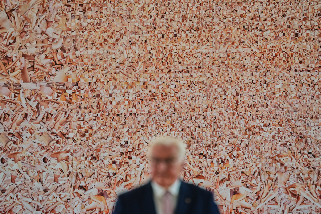 German President Frank-Walter Steinmeier speaks in front of the collage titled "Hard String," an artwork by Monica Bonvicini, during the press preview of a contemporary art exhibition at the German President's residency, Bellevue Palace, in Berlin, Germany, Monday, June 8, 2026. (AP Photo/Markus Schreiber)