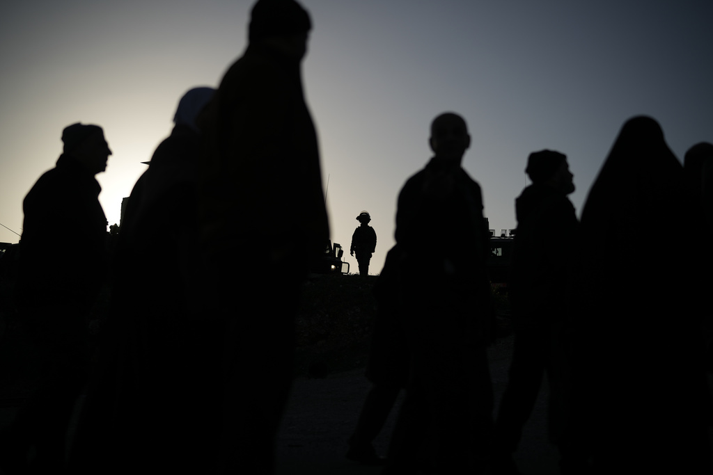 Palestinian worshippers pass through the Israeli military Qalandia checkpoint between the West Bank city of Ramallah and Jerusalem on their way to attend Friday prayers at Al-Aqsa Mosque during the Muslim holy month of Ramadan, Friday, Feb. 20, 2026. (AP Photo/Leo Correa)