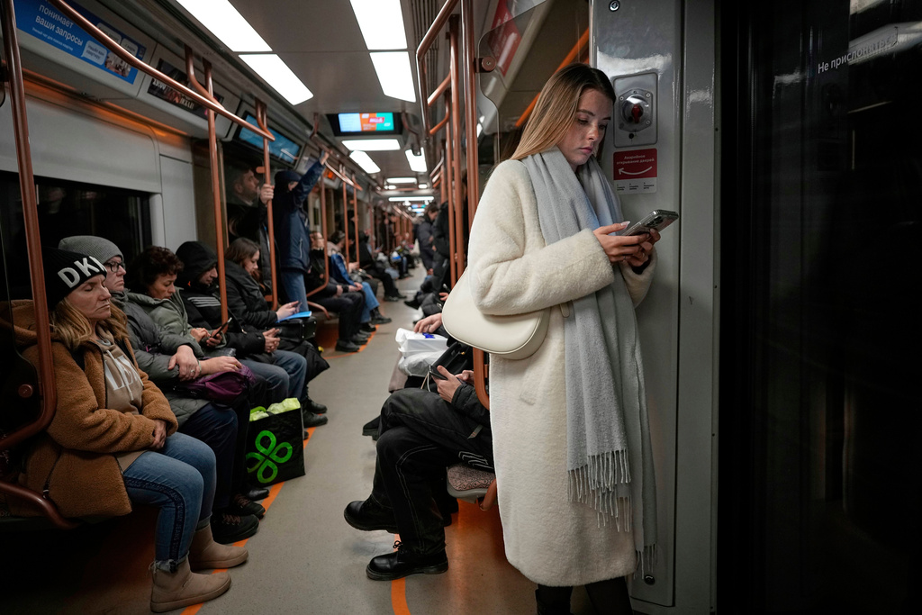 FILE - A woman looks at her smartphone on the subway in Moscow, Russia, March 4, 2025. (AP Photo/Alexander Zemlianichenko, File)