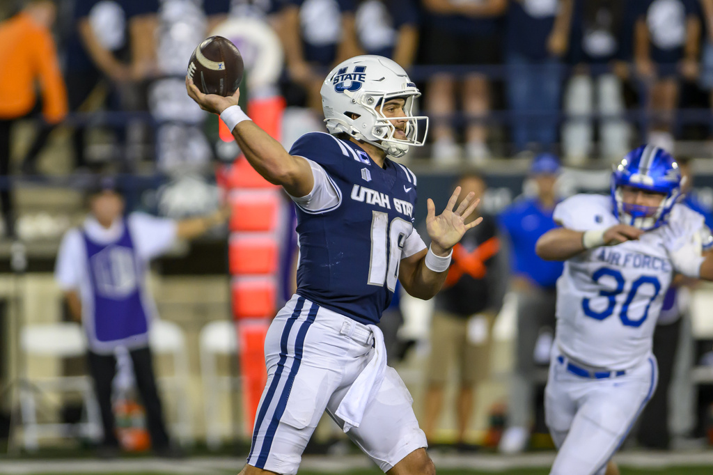 Utah State quarterback Bryson Barnes (16) throws the football in the first half during an NCAA college football game against Air Force, Saturday, Sept. 13, 2025, in Logan, Utah. (AP Photo/Tyler Tate)