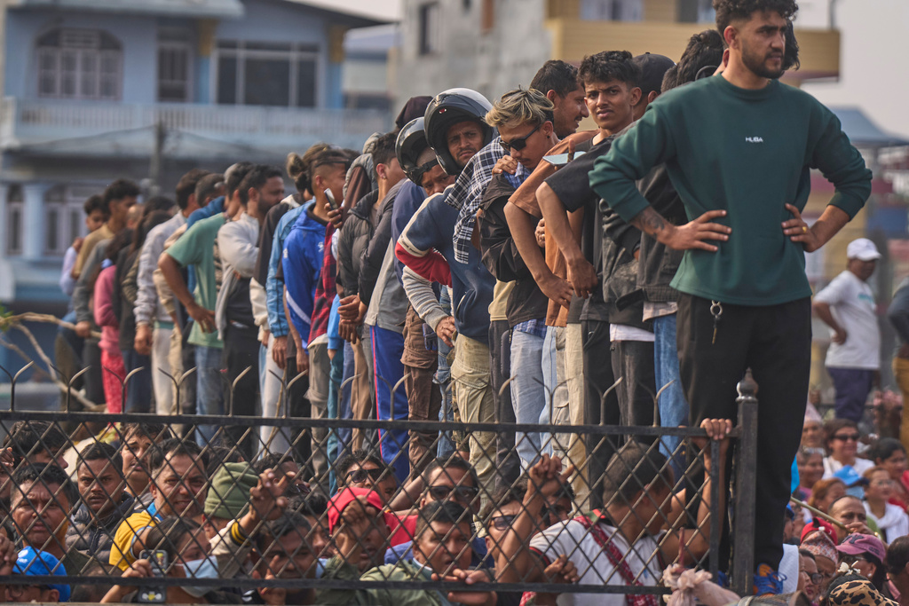 Supporters of the Rastriya Swatantra Party shout slogans as they wait for the arrival of rapper-turned-politician Balendra Shah during an election campaign rally in Chitwan, approximately 180 kilometers (112 miles) west of Kathmandu, Nepal, Friday, Feb. 27, 2026. (AP Photo/Niranjan Shrestha)