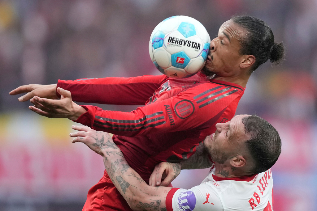 Bayern's Leroy Sane challenges for the ball with Leipzig's David Raum, bottom, during the German Bundesliga soccer match between RB Leipzig and FC Bayern Munich at the Red Bull Arena in Leipzig, Germany, May 3, 2025. (AP Photo/Ebrahim Noroozi, File)