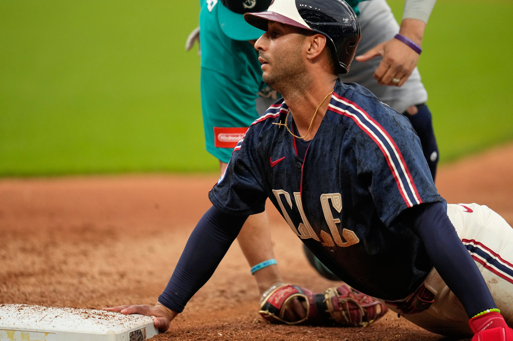 Cleveland Guardians' Brayan Rocchio, right, is picked off of first base by Seattle Mariners first baseman Josh Naylor, left, in the fourth inning of a baseball game in Cleveland, Friday, June 26, 2026. (AP Photo/Sue Ogrocki)